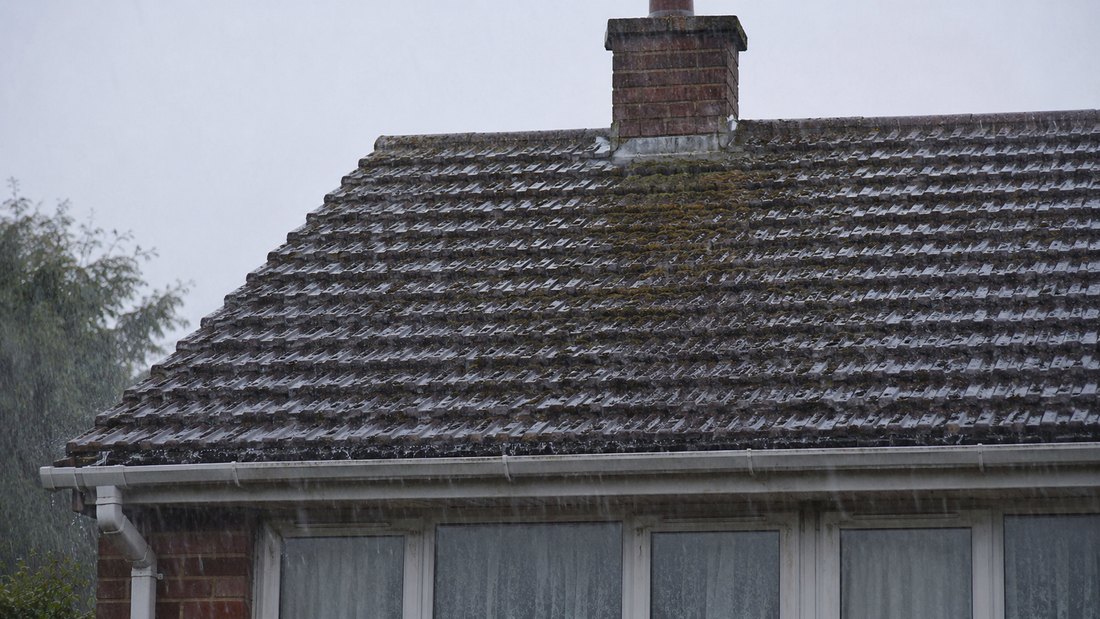 Older tiled roof in wet Greater Manchester weather